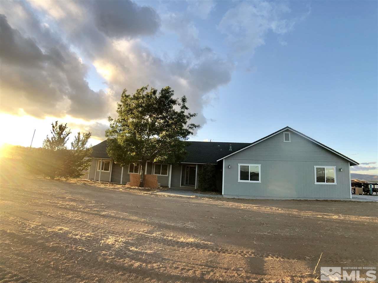 10205 Placerville Road Reno, NV 89508 - Photo 7 of 40 a front view of house with yard and trees in the background
