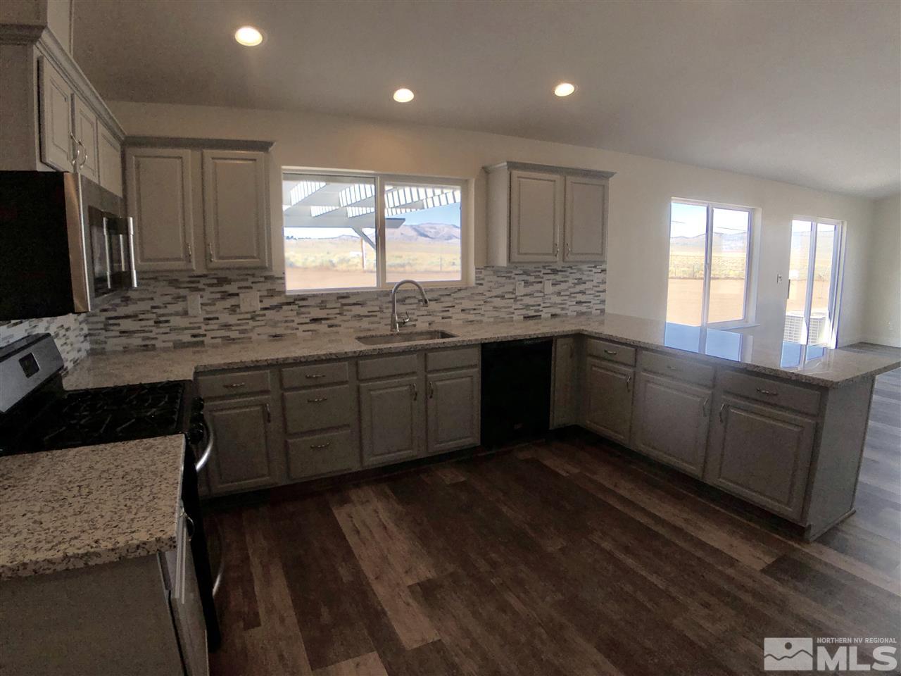 10205 Placerville Road Reno, NV 89508 - Photo 8 of 40 a kitchen with lots of counter space and wooden floor