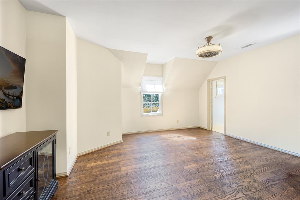 6615 Meadow Road Dallas, TX 75230 - Photo 32 of 39 One of the 4 upstairs bedrooms was used as a dance studio with one mirrored wall, hardwood floors, the mirror can easily be removed. An ensuite bath has been updated.