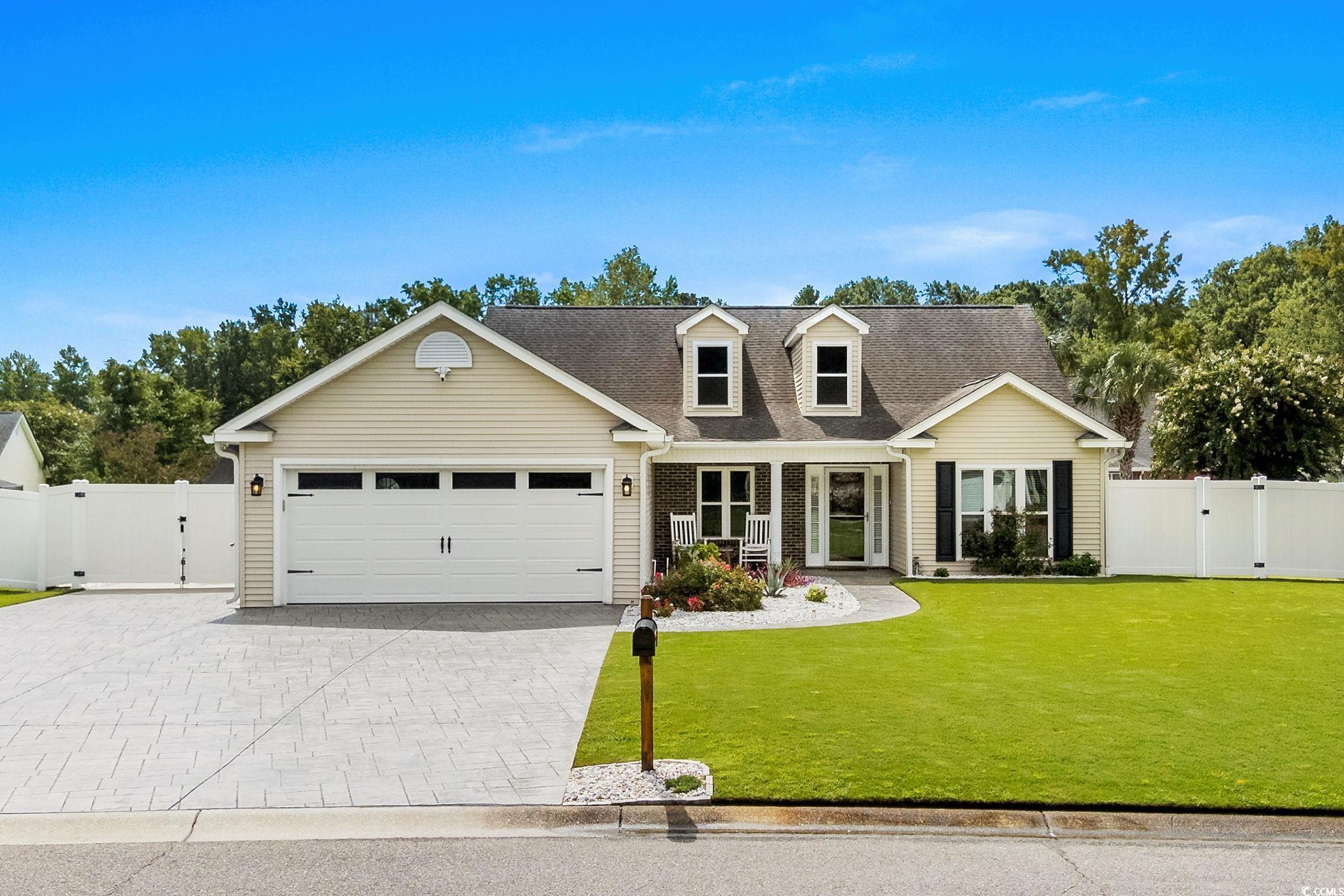 408 Highland Ridge Drive Myrtle Beach, SC 29588 - Photo 1 of 39 View of front facade with a gate, decorative driveway, an attached garage, and a shingled roof