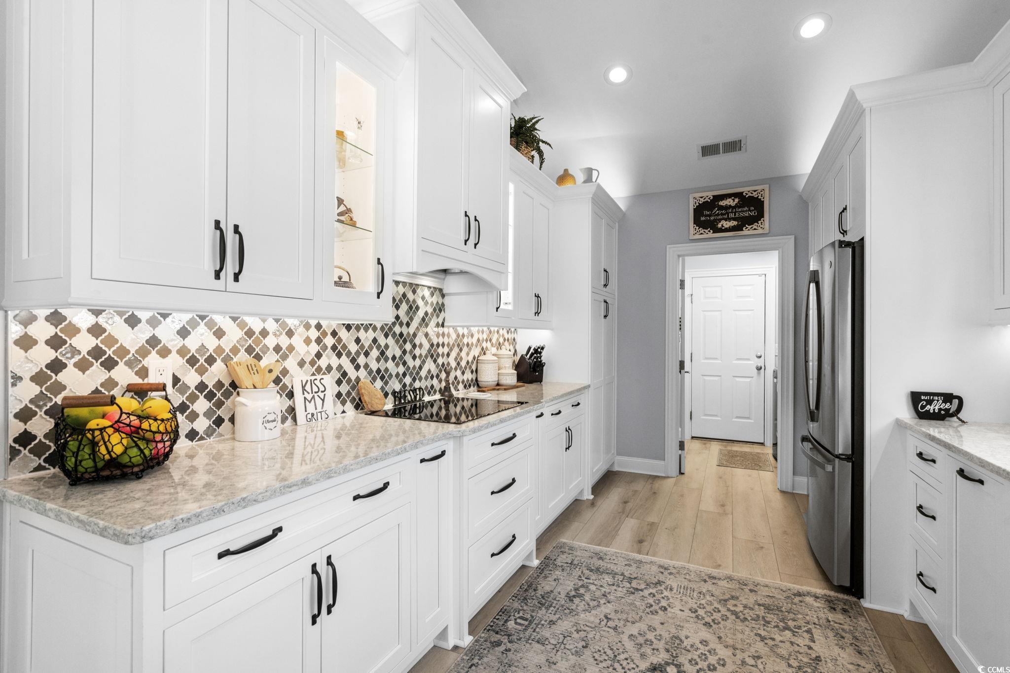 408 Highland Ridge Drive Myrtle Beach, SC 29588 - Photo 12 of 39 Kitchen with tasteful backsplash, white cabinets, freestanding refrigerator, recessed lighting, and light Quartz countertops