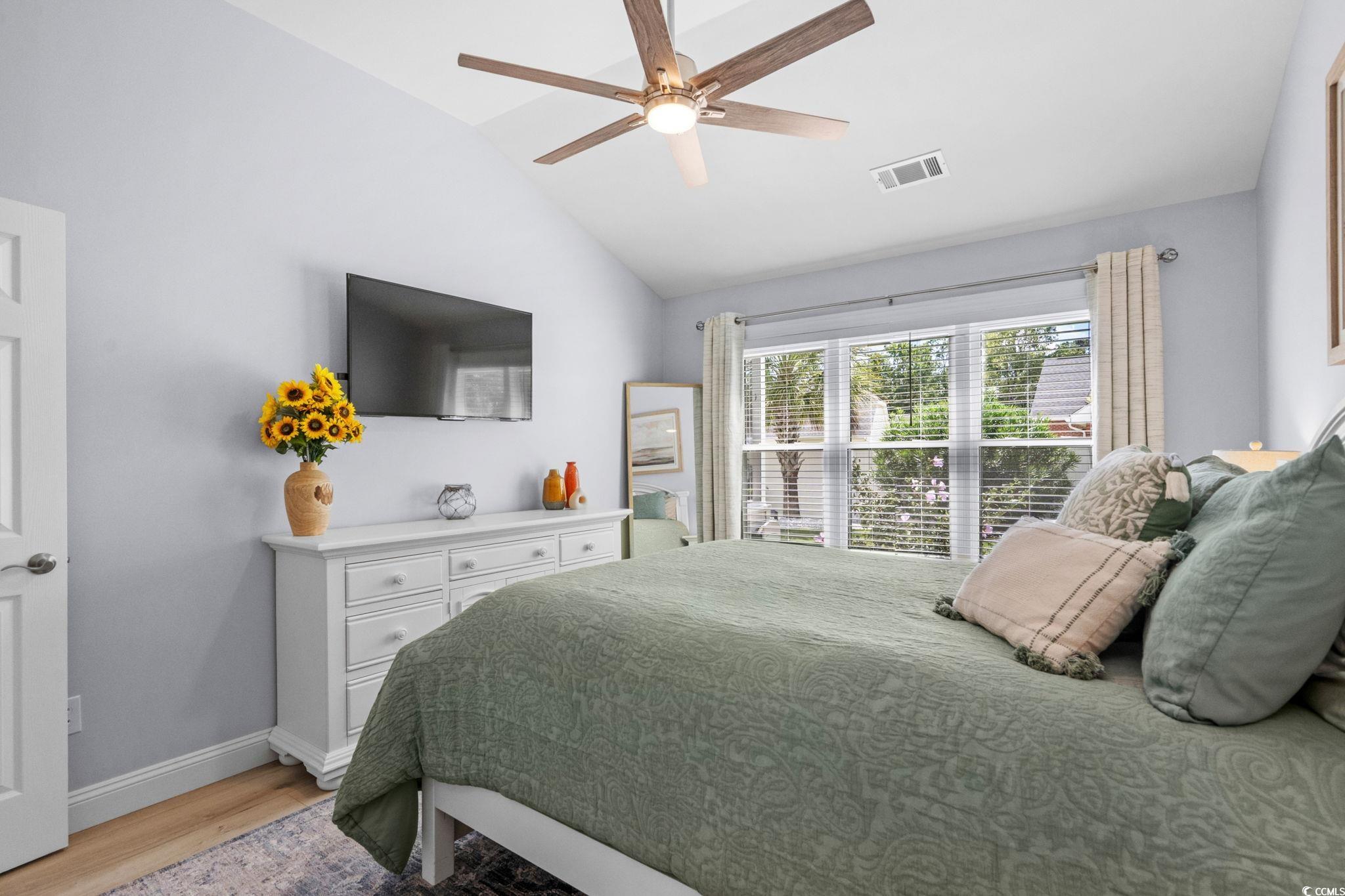 408 Highland Ridge Drive Myrtle Beach, SC 29588 - Photo 19 of 39 Bedroom featuring light wood-type flooring, vaulted ceiling, and a ceiling fan