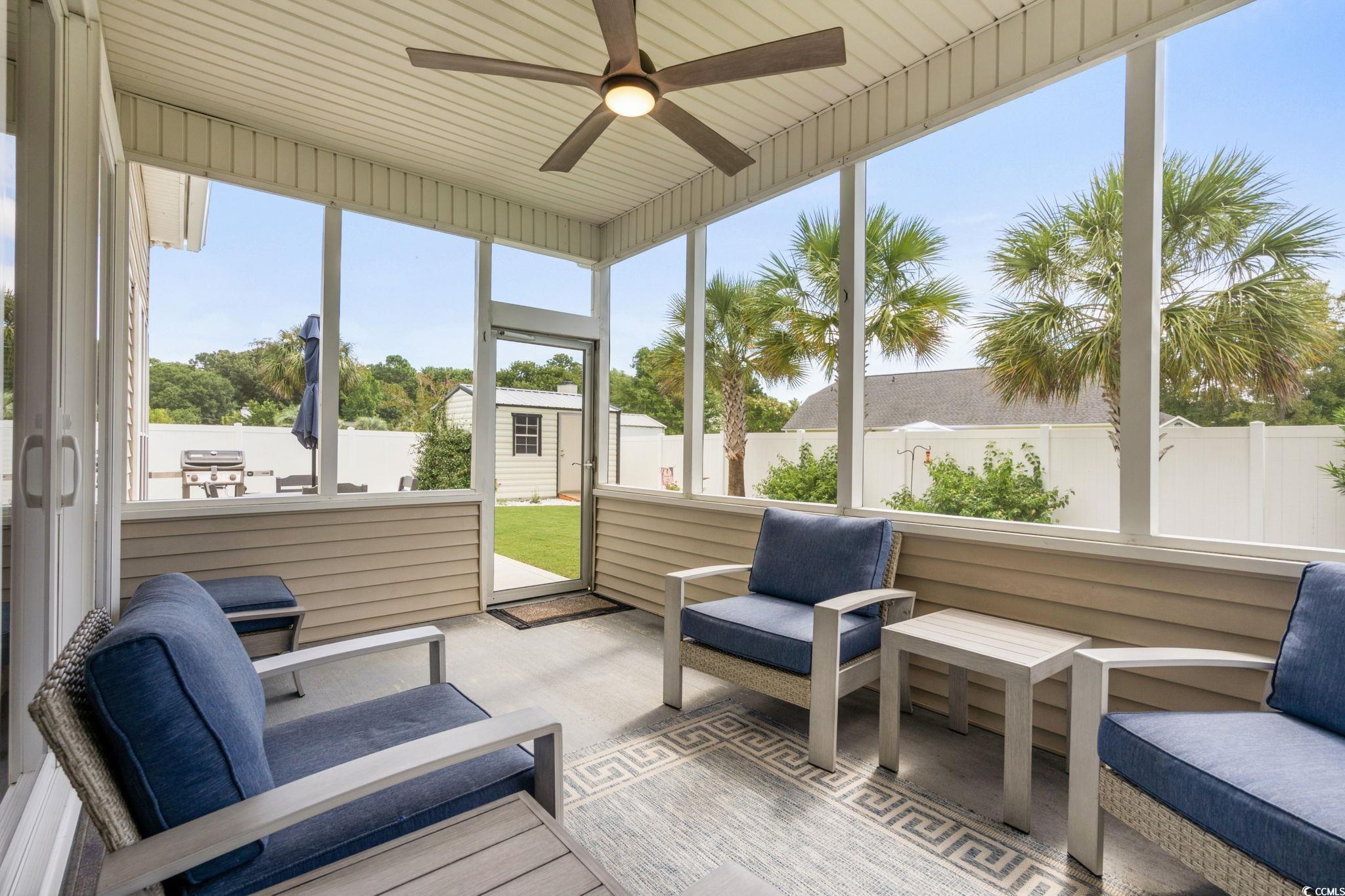 408 Highland Ridge Drive Myrtle Beach, SC 29588 - Photo 28 of 39 Screen Porch with a ceiling fan, an outdoor living space, and healthy amount of natural light