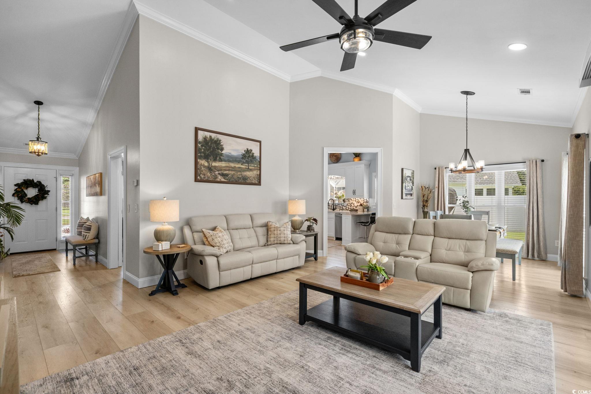 408 Highland Ridge Drive Myrtle Beach, SC 29588 - Photo 5 of 39 Living area with a chandelier, ornamental molding, high vaulted ceiling, light wood-type flooring, and ceiling fan