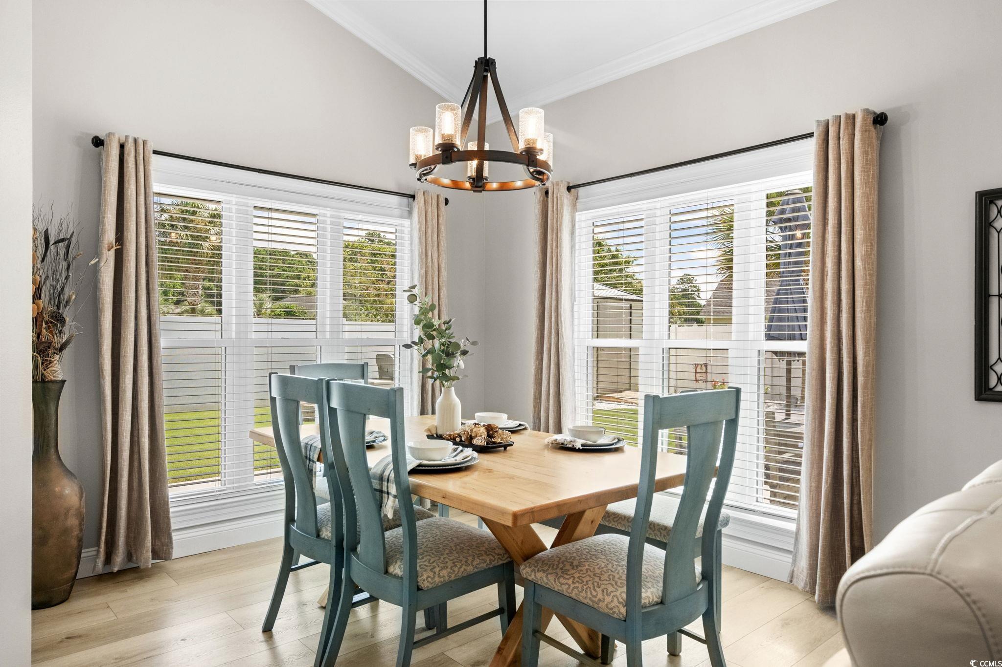 408 Highland Ridge Drive Myrtle Beach, SC 29588 - Photo 8 of 39 Dining room with light wood-style floors, crown molding, and a chandelier