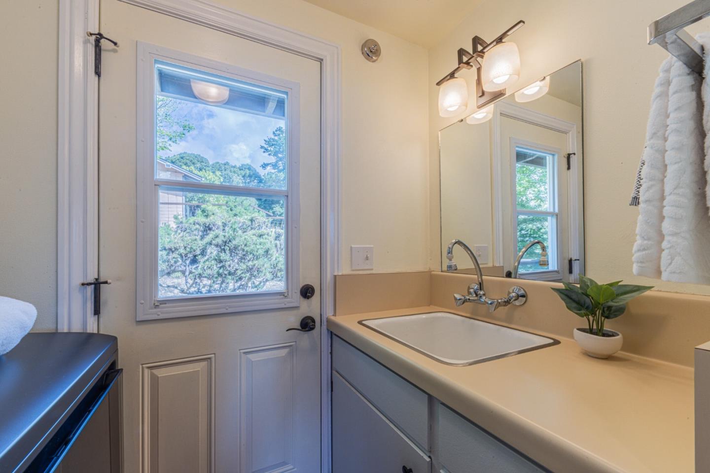 430 Quail Run Road Aptos, CA 95003 - Photo 33 of 34 a bathroom with a granite countertop sink a large mirror a and a window