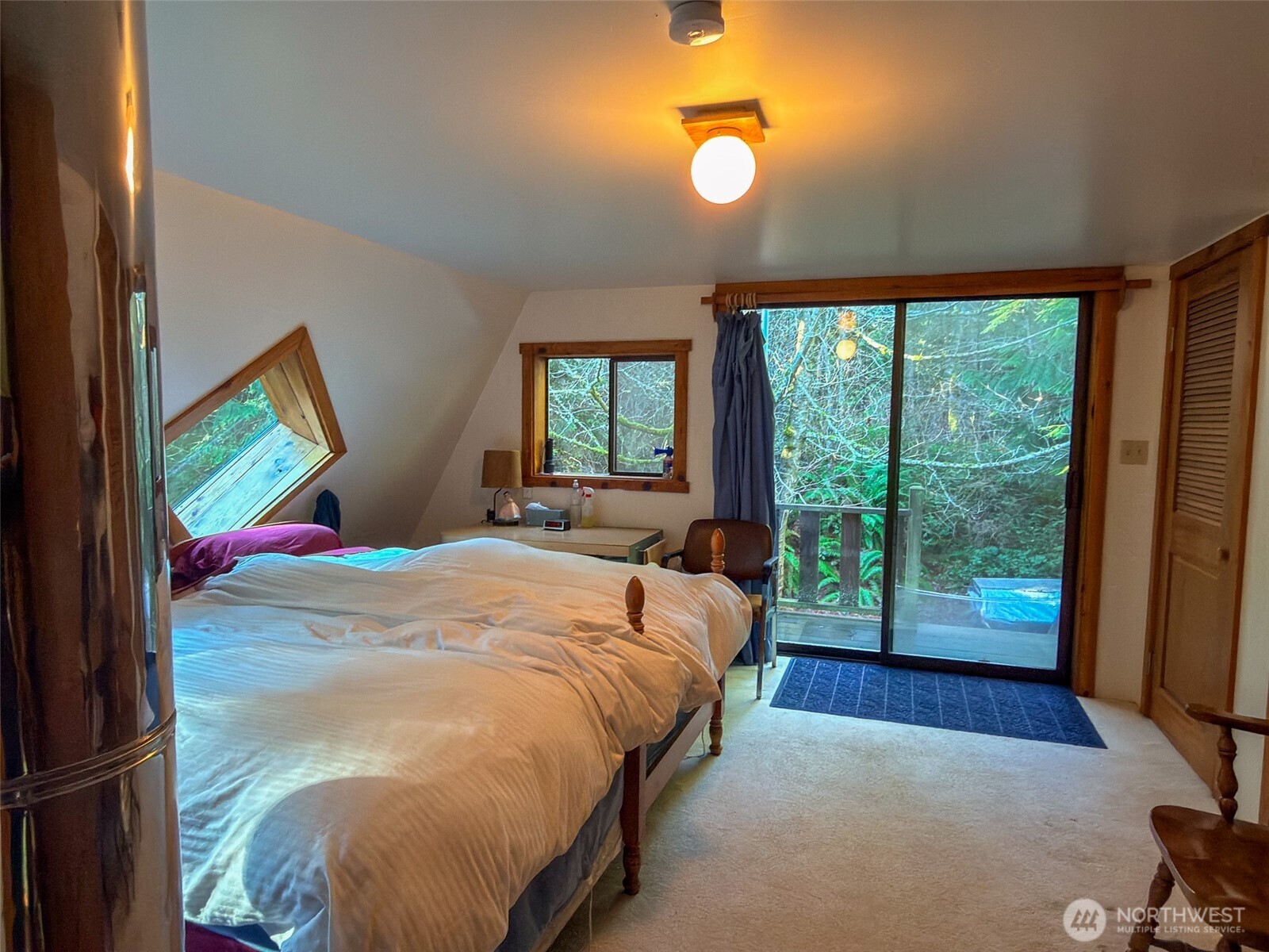 890 Black Bear Road Port Townsend, WA 98368 - Photo 29 of 40 a bed sitting in a bedroom next to a window