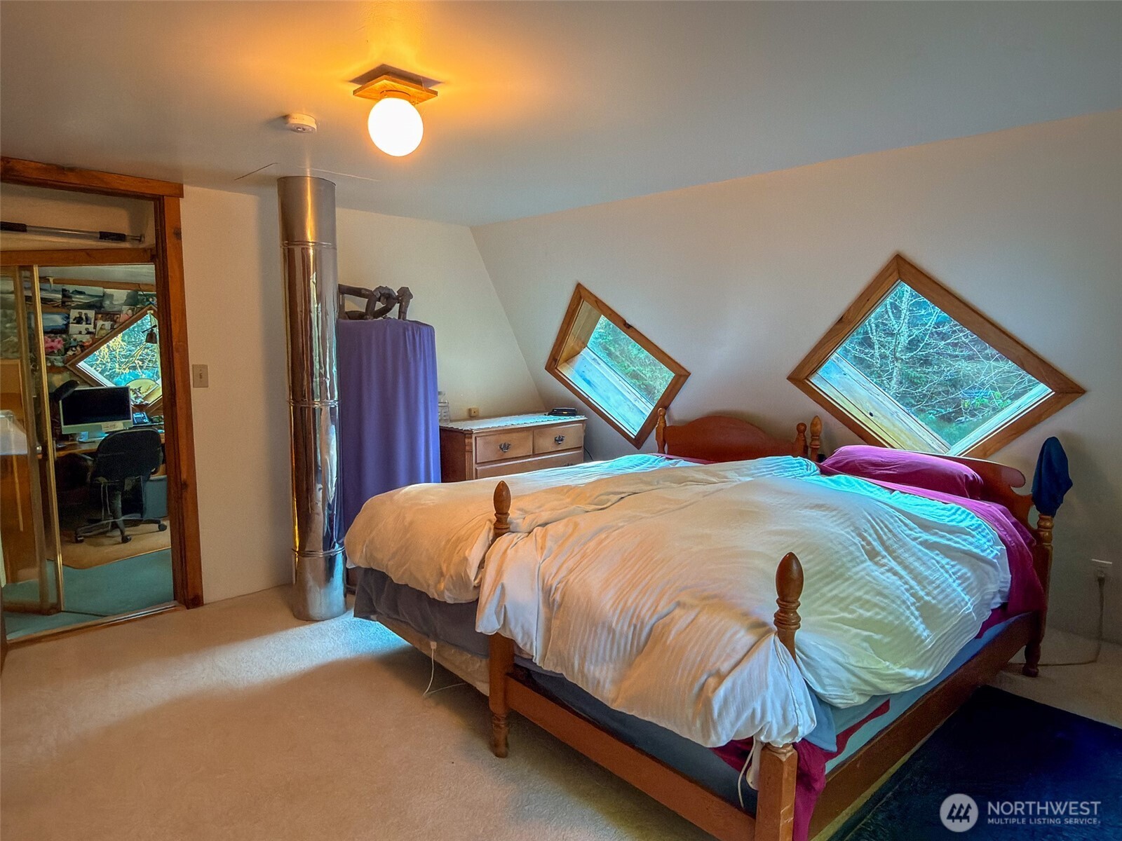 890 Black Bear Road Port Townsend, WA 98368 - Photo 31 of 40 a bed sitting in a bedroom next to a window