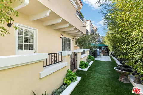 a view of a patio with table and chairs and potted plants