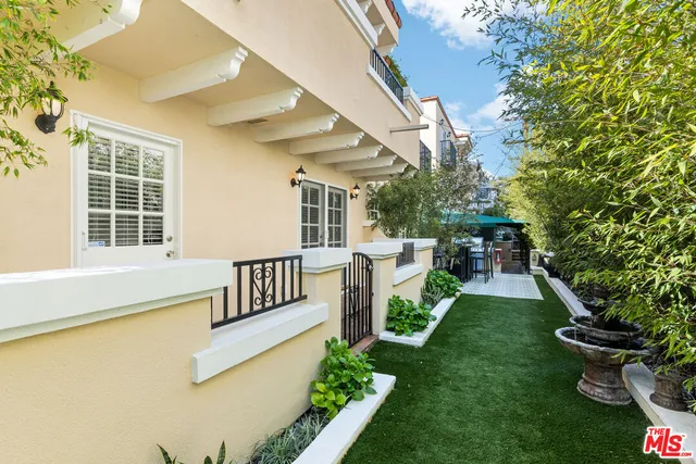 a view of a patio with table and chairs and potted plants