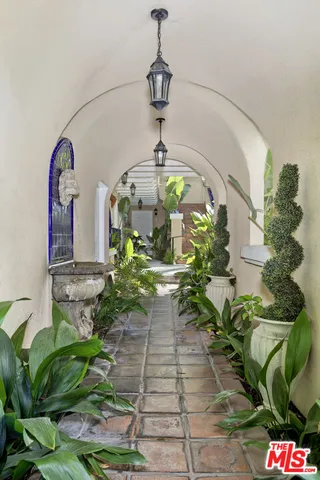 a vase of flowers sitting on a floor