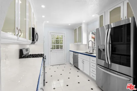 a kitchen with stainless steel appliances a refrigerator and a sink