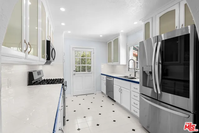 a kitchen with stainless steel appliances a refrigerator and a sink