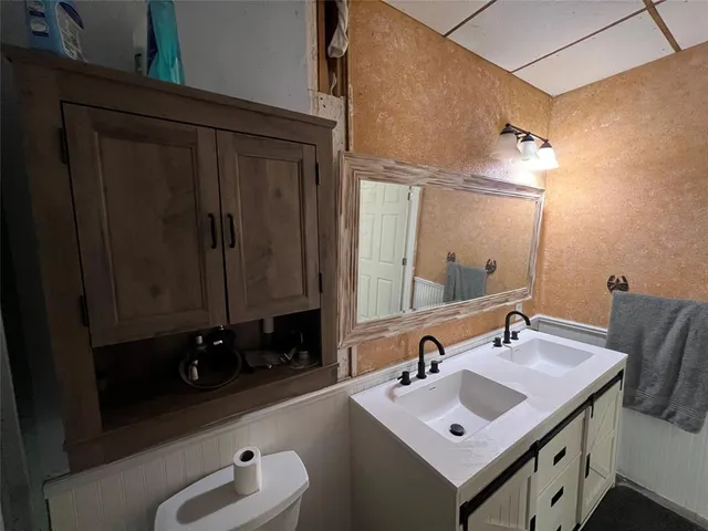 a bathroom with a sink vanity and a mirror