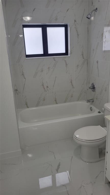 1836 Northwest 70th Street Miami, FL 33147 - Photo 2 of 5 a bathroom with a toilet and a bathtub
