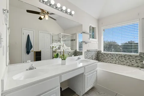 a view of walk in closet with clothes