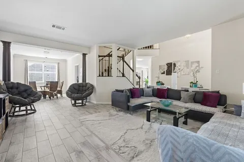 a living room with furniture and a mirror