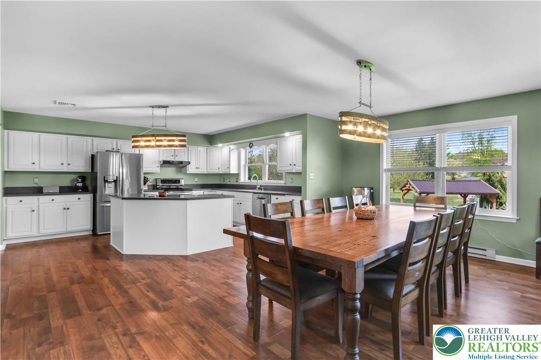 4263 Park Avenue Slatington, PA 18080 - Photo 14 of 54 a kitchen with a dining table chairs stainless steel appliances and cabinets