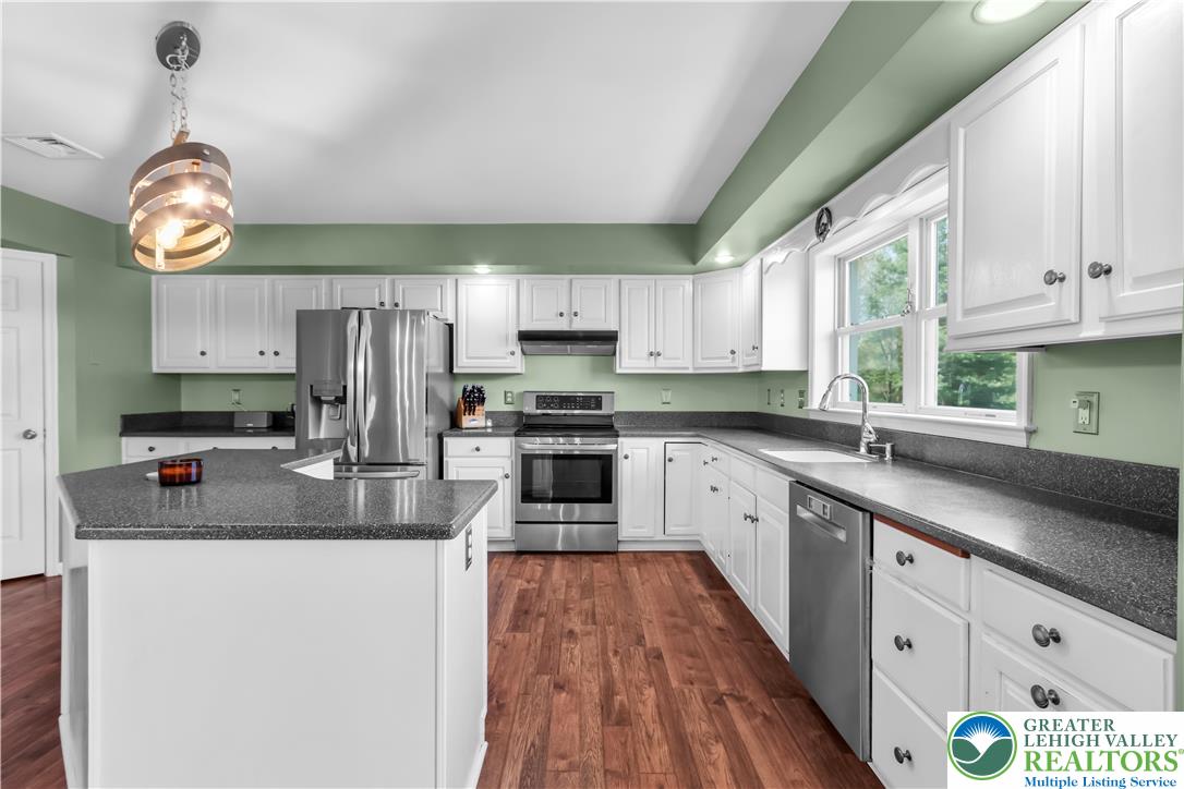 4263 Park Avenue Slatington, PA 18080 - Photo 16 of 54 a kitchen with stainless steel appliances granite countertop a sink a stove cabinets and a window