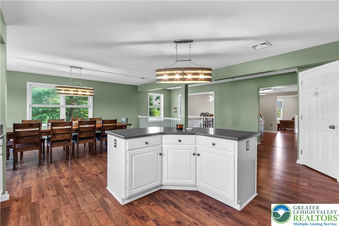 4263 Park Avenue Slatington, PA 18080 - Photo 17 of 54 a open kitchen with wooden floor a sink dishwasher a dining table and chairs with wooden floor