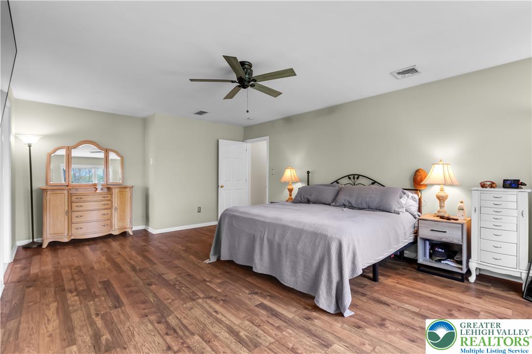 4263 Park Avenue Slatington, PA 18080 - Photo 23 of 54 a spacious bedroom with a bed windows and wooden floor