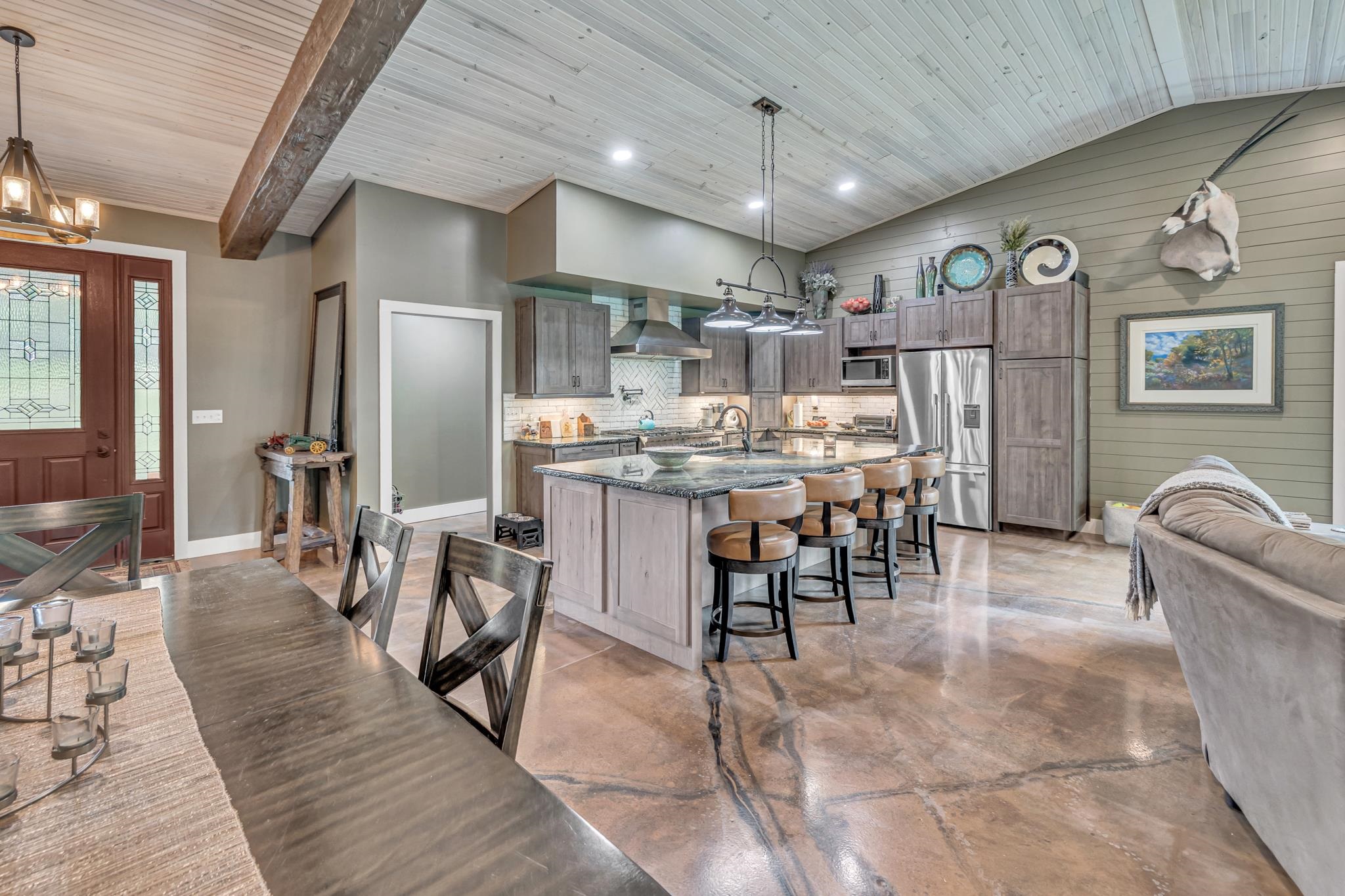 350 Hamilton Road Springville, TN 38256 - Photo 7 of 40 Spacious open-concept interior featuring a vaulted wood-paneled ceiling with an exposed beam