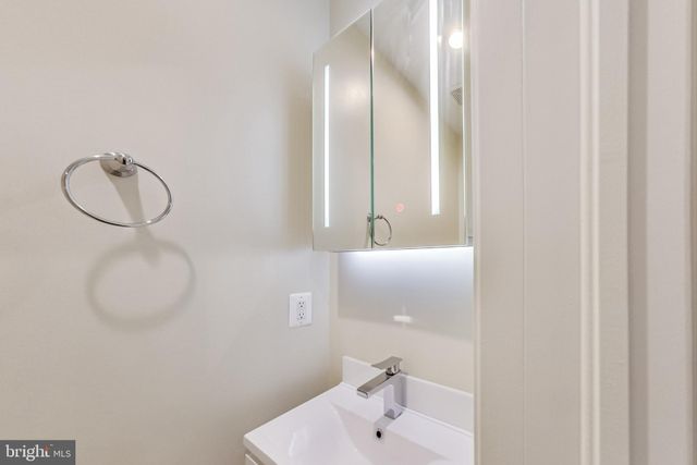 a bathroom with a sink and mirror