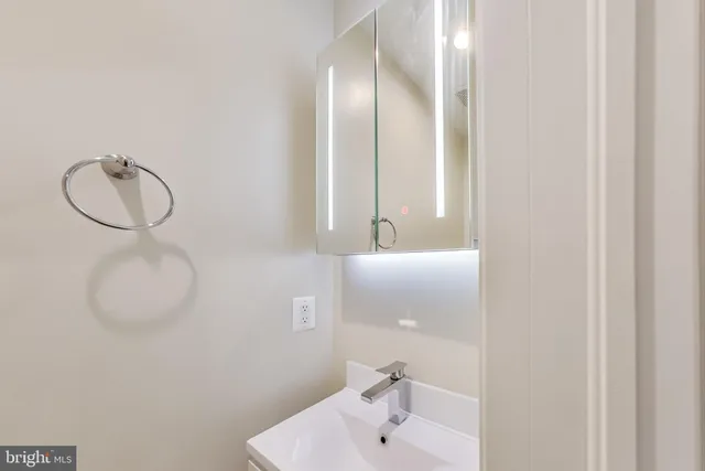 a bathroom with a sink and mirror