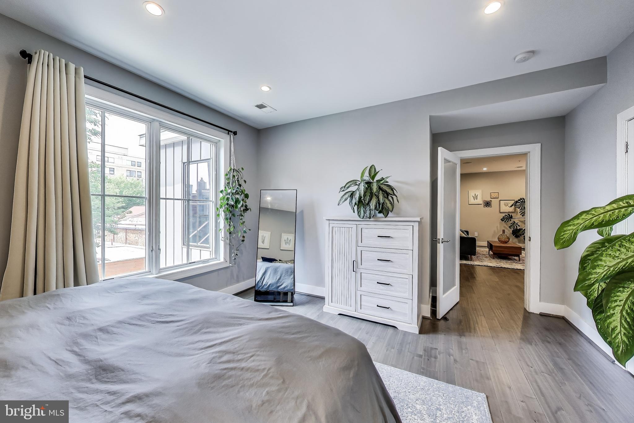 625 Park Road Northwest, Unit 206 Washington, DC 20010 - Photo 13 of 21 a spacious bedroom with a large bed and a window