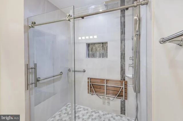 a bathroom with a shower and a glass door