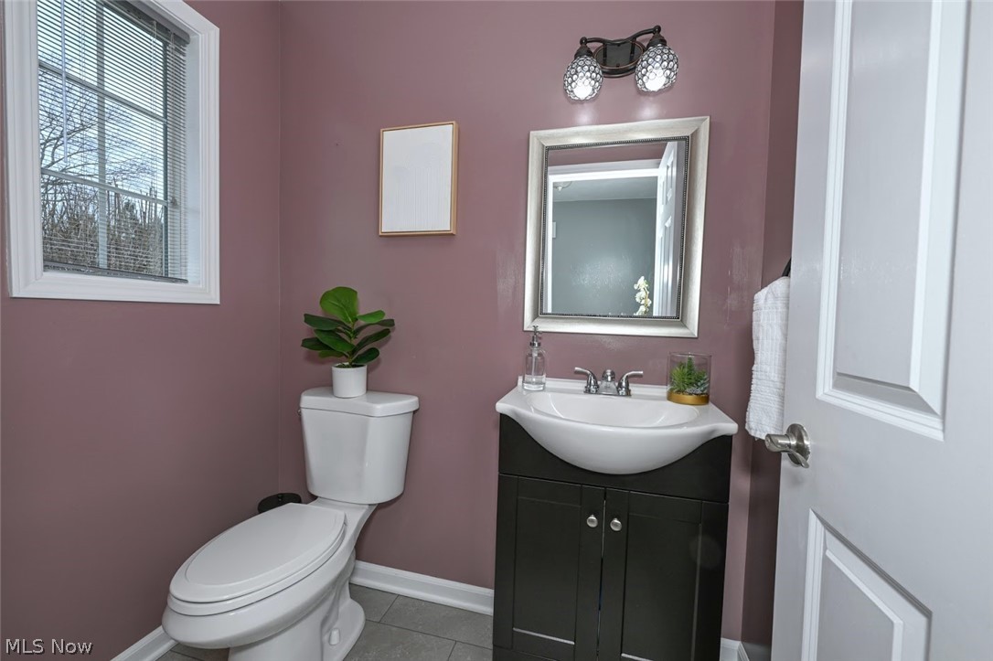 3880 Selnik Road Kent, OH 44240 - Photo 23 of 46 *FIRST FLOOR BATHROOM W/CRYSTAL LIGHTING AND GREY TILED FLOORING ~
