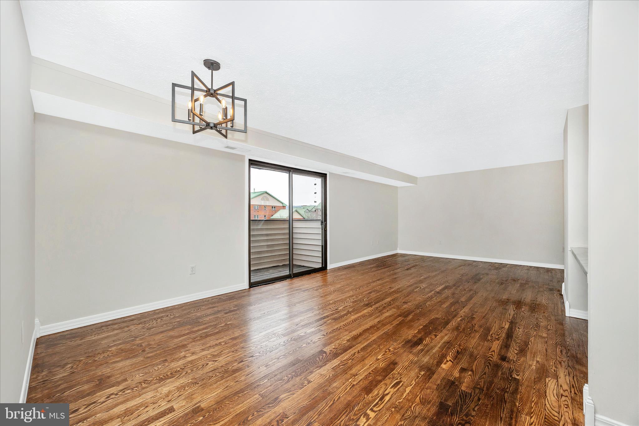 550 Heather Ridge Drive, Unit K Frederick, MD 21702 - Photo 11 of 45 a view of empty room with wooden floor
