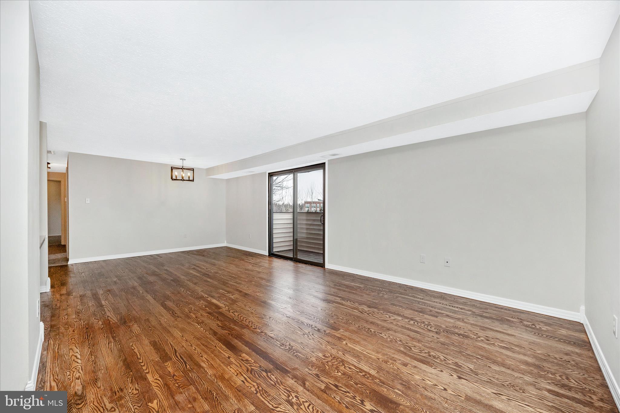 550 Heather Ridge Drive, Unit K Frederick, MD 21702 - Photo 6 of 45 an empty room with wooden floor and windows