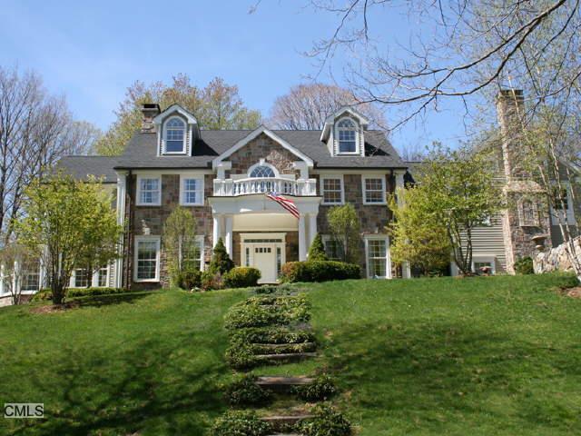 41 Chestnut Woods Road Redding, CT 06896 - Photo 1 of 1 a front view of a house with a garden