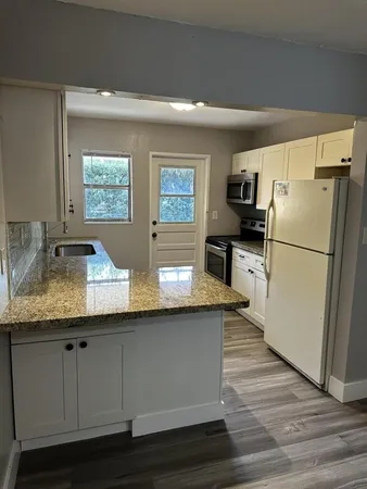 a kitchen with counter top space and stainless steel appliances