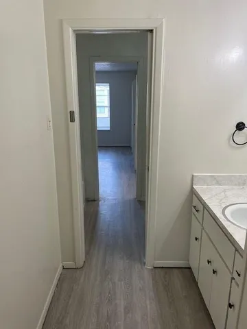 a view of a hallway with wooden floor