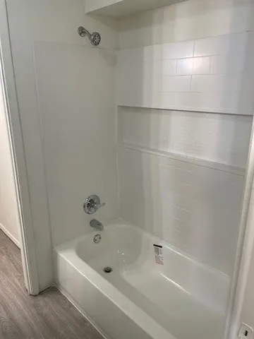 a white bath tub and a shower