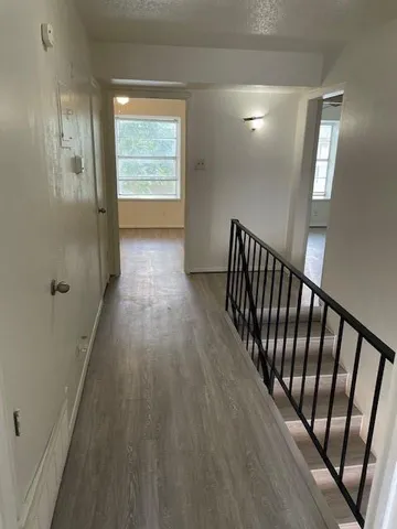 a view of hallway with wooden floor
