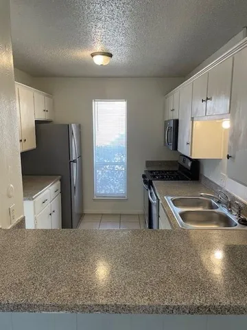 a kitchen with a refrigerator and a sink