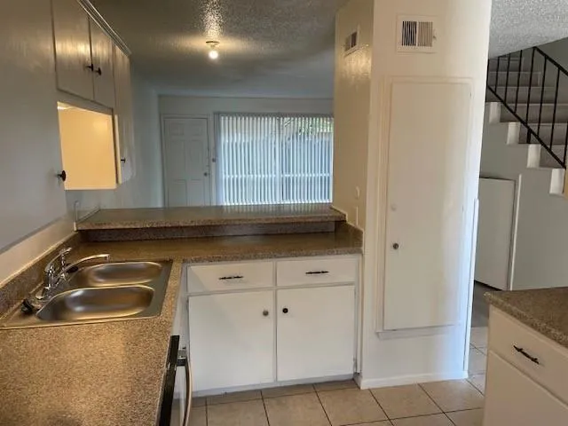 a kitchen with a sink and cabinets