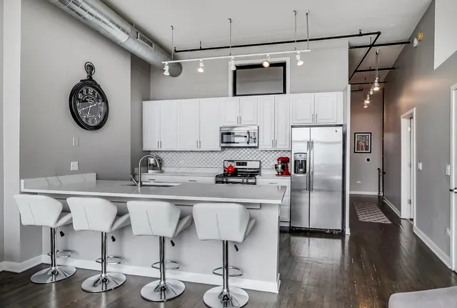 a kitchen with stainless steel appliances a stove refrigerator and a refrigerator