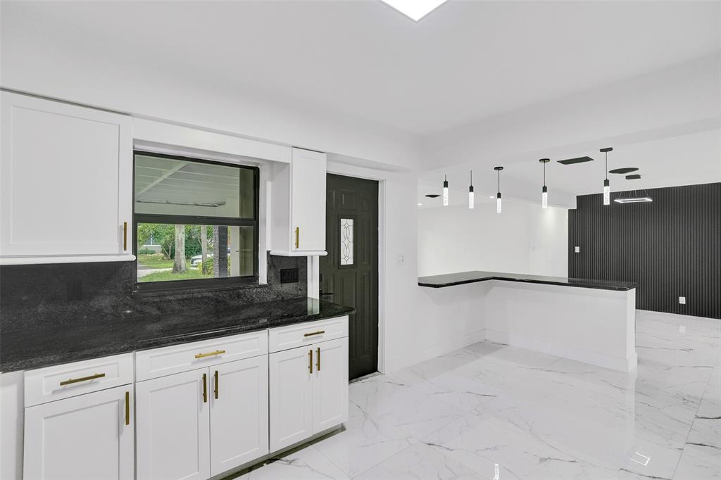 5840 Southwest 14th Street Plantation, FL 33317 - Photo 13 of 33 a bathroom with a granite countertop sink a mirror and shower