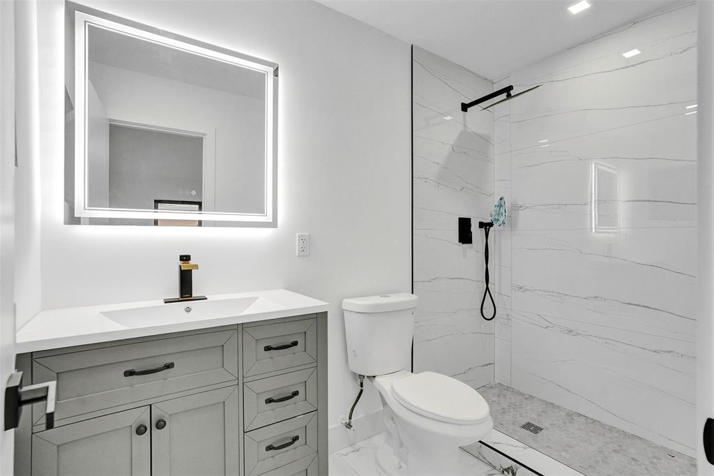 5840 Southwest 14th Street Plantation, FL 33317 - Photo 16 of 33 a bathroom with a sink a toilet and shower