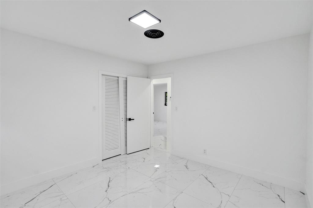 5840 Southwest 14th Street Plantation, FL 33317 - Photo 17 of 33 an empty room with glass door