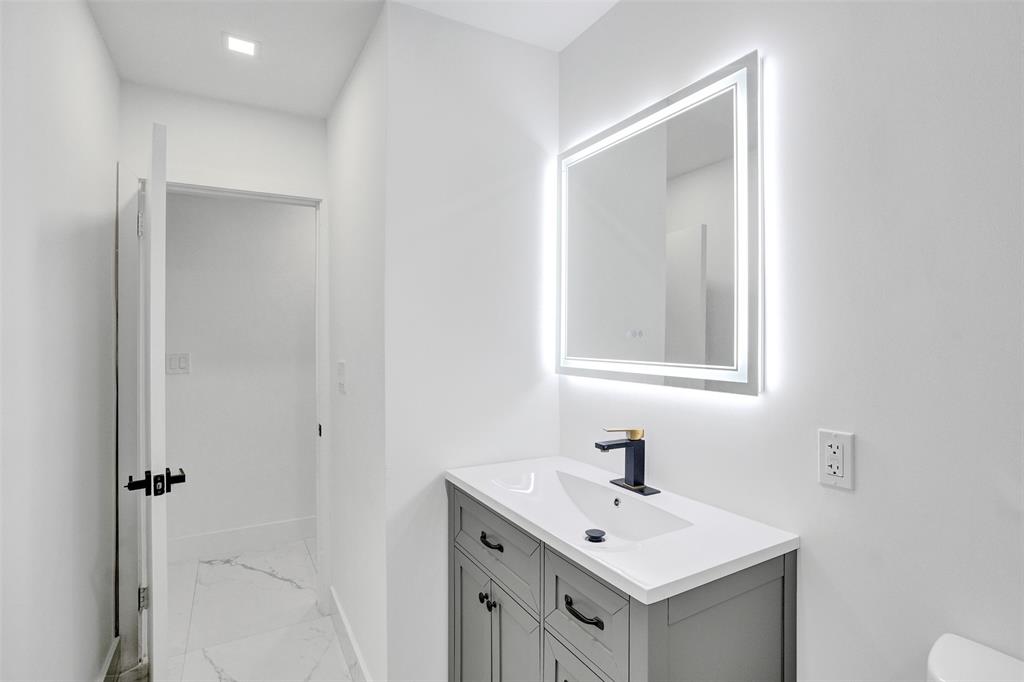 5840 Southwest 14th Street Plantation, FL 33317 - Photo 19 of 33 a bathroom with a sink vanity and a mirror