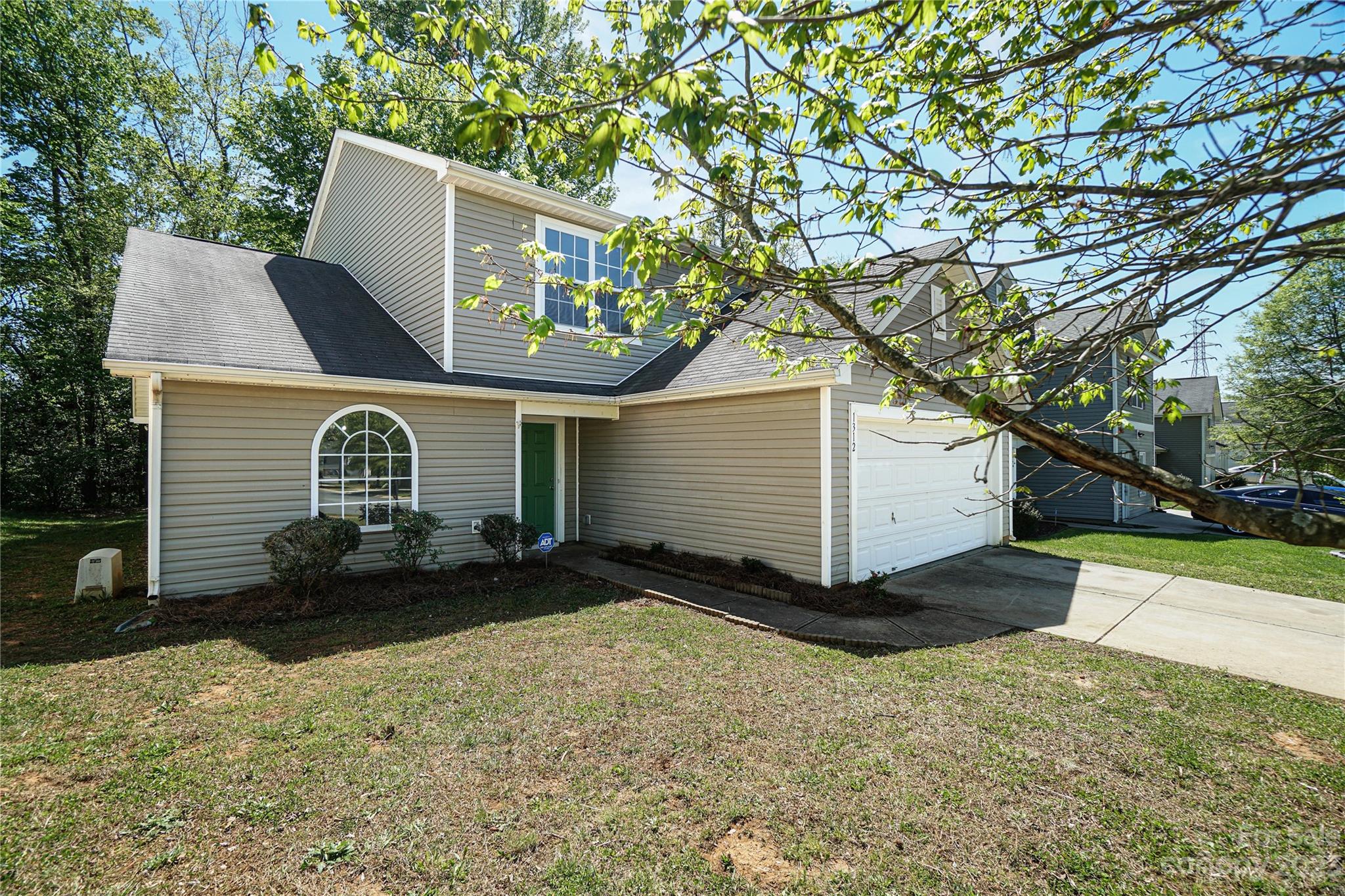 1312 Ben Livingston Road Charlotte, NC 28214 - Photo 1 of 12 a front view of a house with a yard