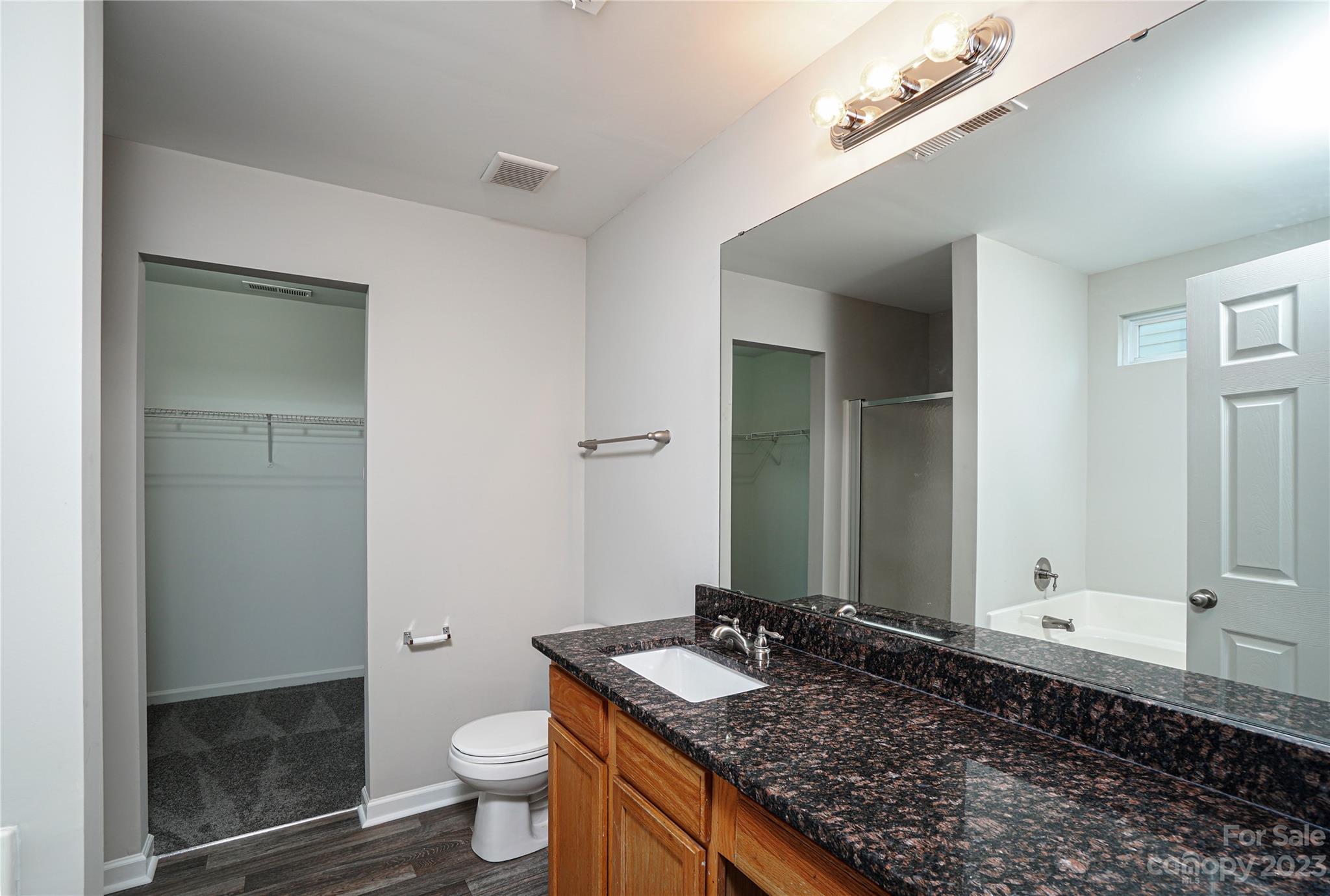 1312 Ben Livingston Road Charlotte, NC 28214 - Photo 11 of 12 a bathroom with a granite countertop sink and a mirror