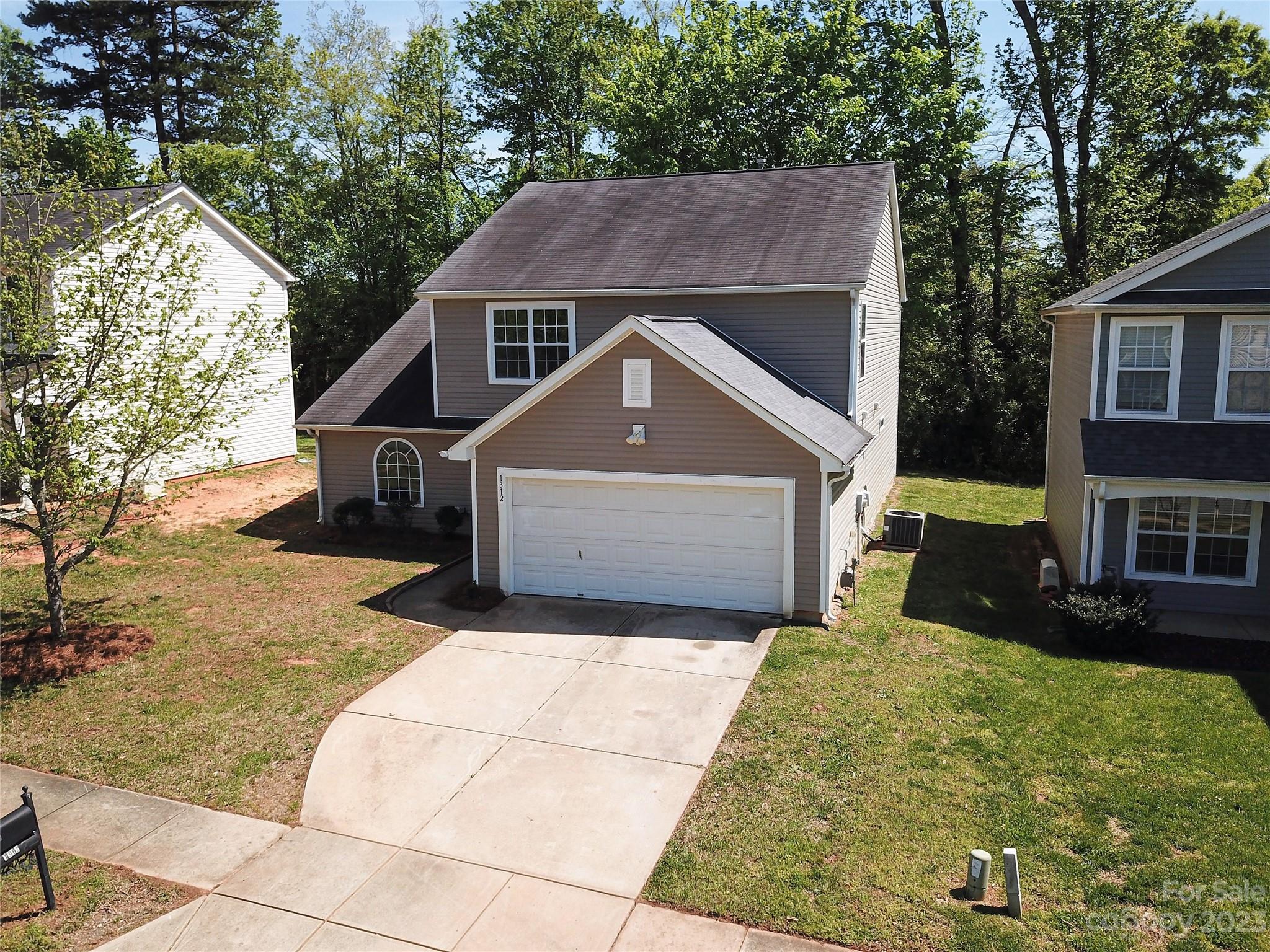 1312 Ben Livingston Road Charlotte, NC 28214 - Photo 2 of 12 a front view of a house with a yard and garage