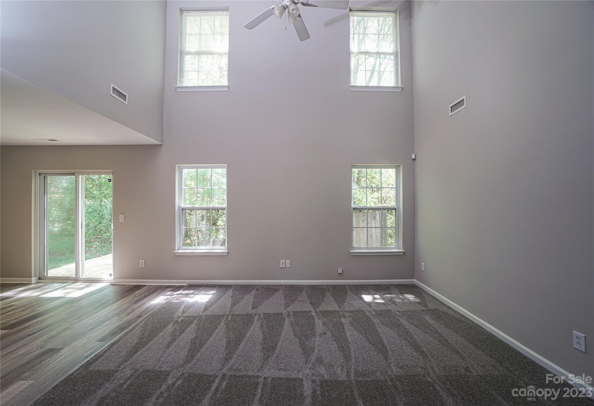 1312 Ben Livingston Road Charlotte, NC 28214 - Photo 4 of 12 an empty room with wooden floor and windows