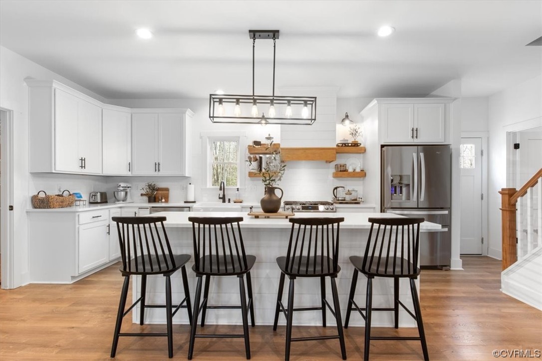 10100 Winterpock Road Chesterfield, VA 23832 - Photo 8 of 29 a kitchen with stainless steel appliances granite countertop a dining table chairs refrigerator and microwave